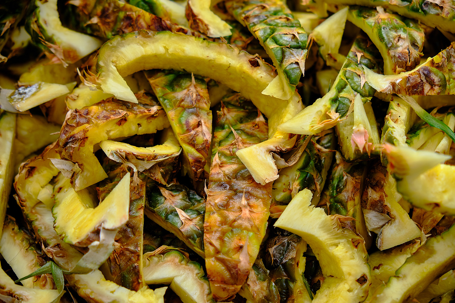 Cut out pineapple skin background.  Pile of sliced rind with flesh removed piled up in a nice designed background.