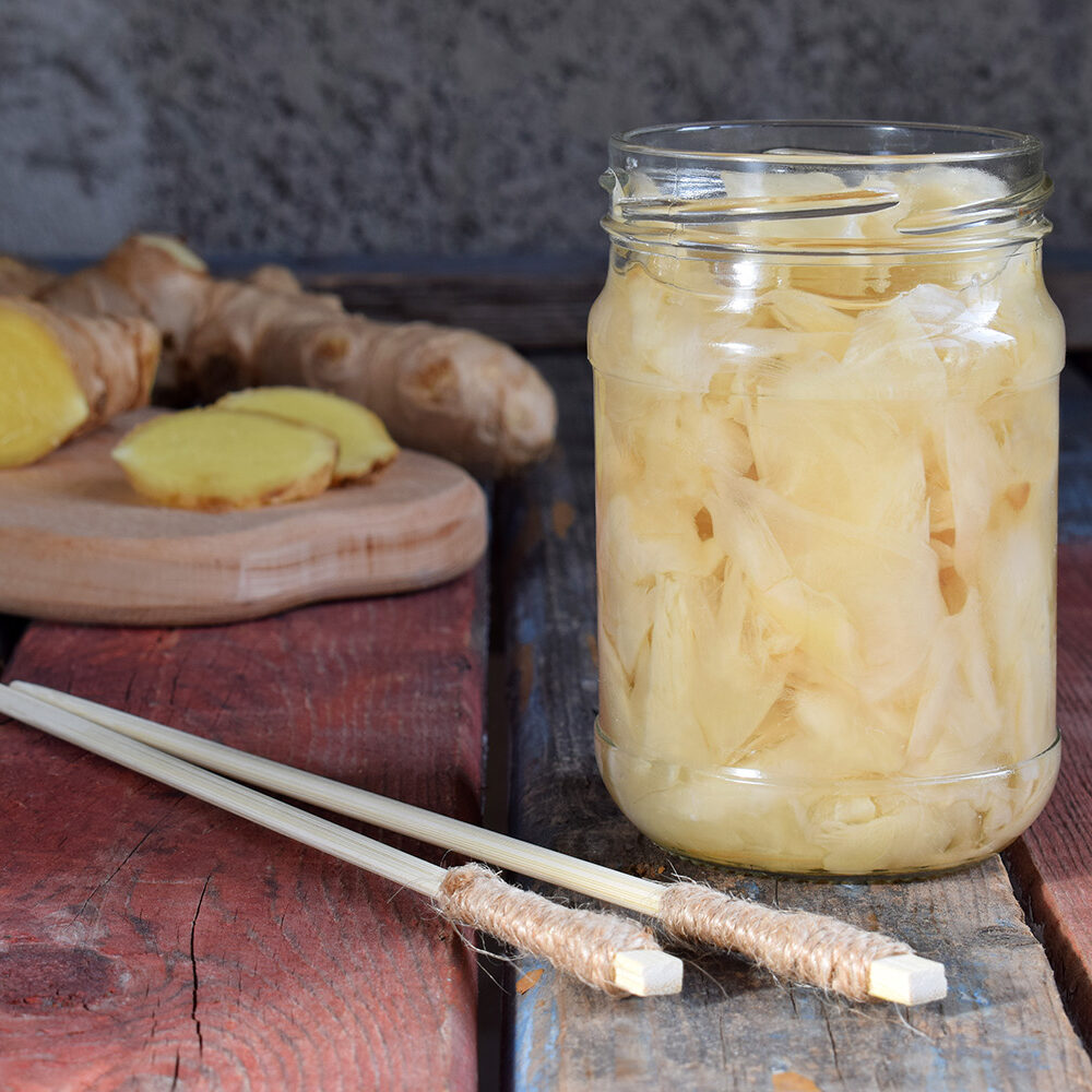 Pickled ginger slices and wooden chopsticks. Ingredient for sushi. Healthy food. Traditional Japanese condiment.